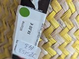 a basket with a tag on it sitting on a table