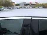 a white car parked in a parking lot with other cars