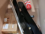a cardboard box with a broom and other items in it