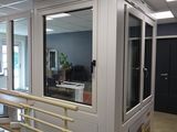 many windows in this room with a railing and stairs