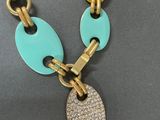 a close up of a necklace with a disc on it
