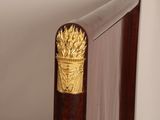 a close up of a bed with a wooden headboard