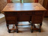 a wooden desk with a drawer on top of it