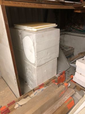 a pile of boxes and boxes on the floor in a room