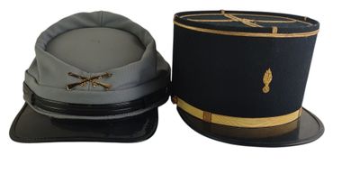 two hats are sitting next to each other on a white surface