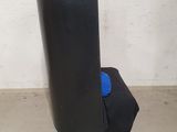 a large black object sitting on the floor next to a white wall