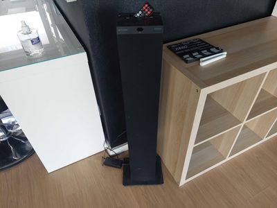a picture of a living room with a television and speakers