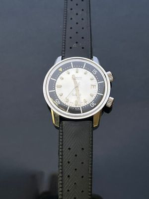 a watch that is sitting on a black table