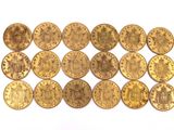 a close up of a bunch of gold coins on a white surface