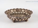 an image of a silver plate with a decorative design on it