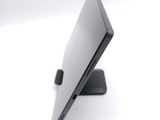 a laptop computer sitting on a stand on a white surface
