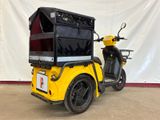 a yellow motorcycle with a black box on the back of it