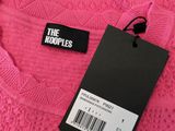 the koople pink sweater with black tag