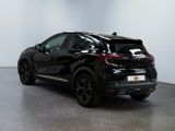 the rear of a black nissan c - hr suv parked in a showroom