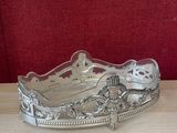 a silver plate on a wooden table with a red background