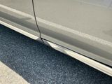 a close up of a car ' s door handle and door sill