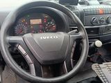 a steering wheel and dashboard of a truck with a laptop on the dashboard