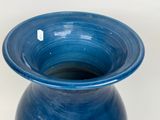 a blue vase that is sitting on a table