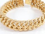 a close up of a gold bracelet on a white background