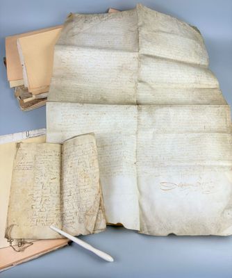 an old paper with writing on it and a pen next to it