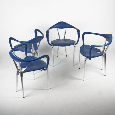 three blue chairs and a table in a white room
