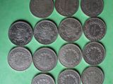 a close up of a bunch of coins on a green surface