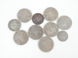 a lot of coins that are on a white surface