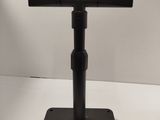 a close up of a black stand on a white surface