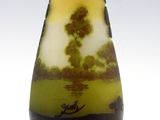 a glass vase with a picture of a landscape on it