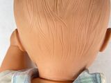 a doll that has a bow tie on it ' s head