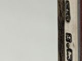 a close up of a metal object on a white surface