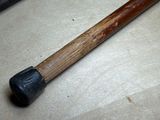 a hammer that is laying on the floor next to a piece of wood