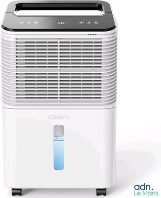 a white air conditioner sitting on top of a white table