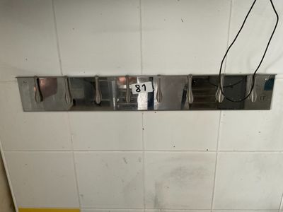 a urinal in the corner of a bathroom with a sign on it
