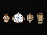 four different types of watches are displayed on a black surface