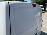 a white van that is parked in a parking lot