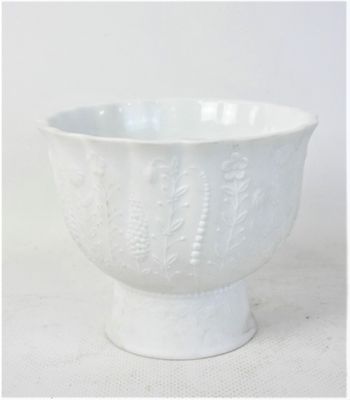 a close up of a white bowl on a table