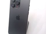a black iphone sitting on top of a stand