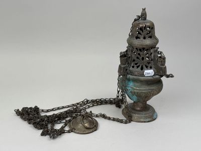 an old metal object with a chain around it and a bell