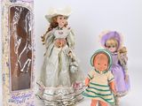 two dolls are standing next to each other in front of a box