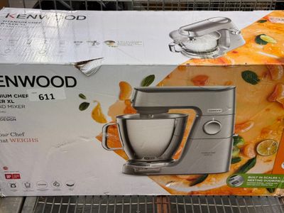 boxes of kenwood stand mixers are on display in a store