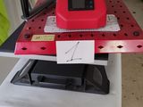 a red ironing board with a black iron on top of it