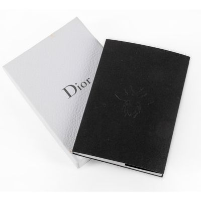 black and white photo of a book with a logo on it