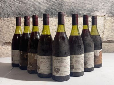six bottles of wine are lined up in a row on a table