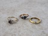 three different colored rings sitting on top of a white surface