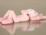a pink baby laying on its back on a table