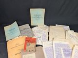 some old papers are piled on top of each other on a black surface