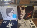 three records sitting on a table in front of a window