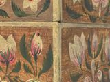 a small wooden box with flowers painted on it
