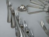 a lot of spoons and spoon knives on the table